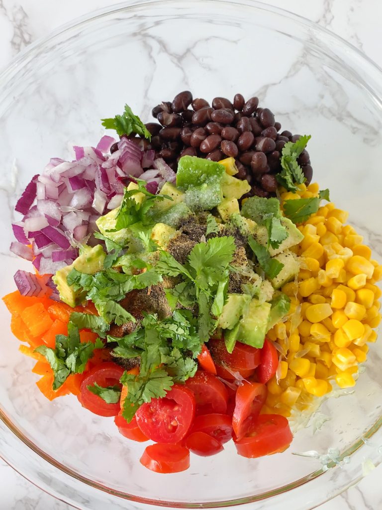 bowl of black beans, corn, tomatoes, peppers, onions, avocado, and cilantro