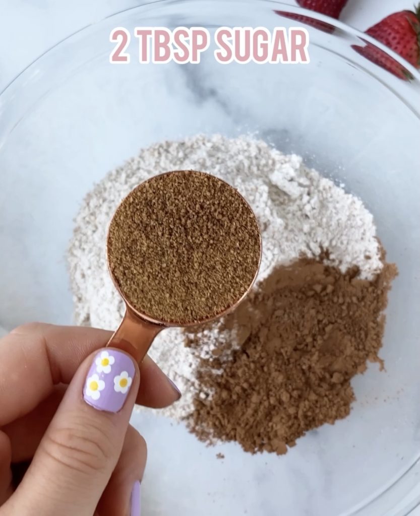 coconut sugar in measuring cup over a bowl