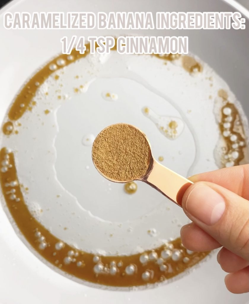 cinnamon in a measuring spoon over a pan