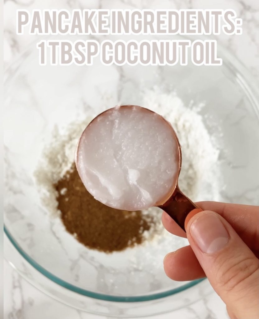 coconut oil in a measuring cup over a bowl