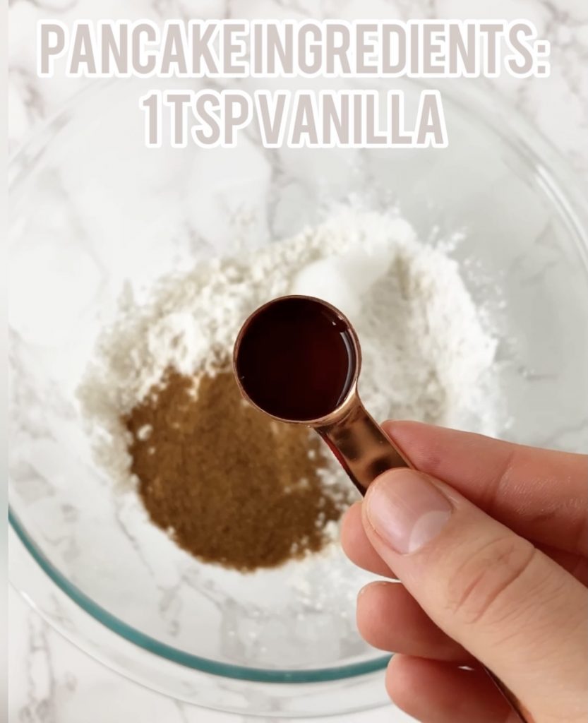 vanilla in a measuring spoon over a bowl