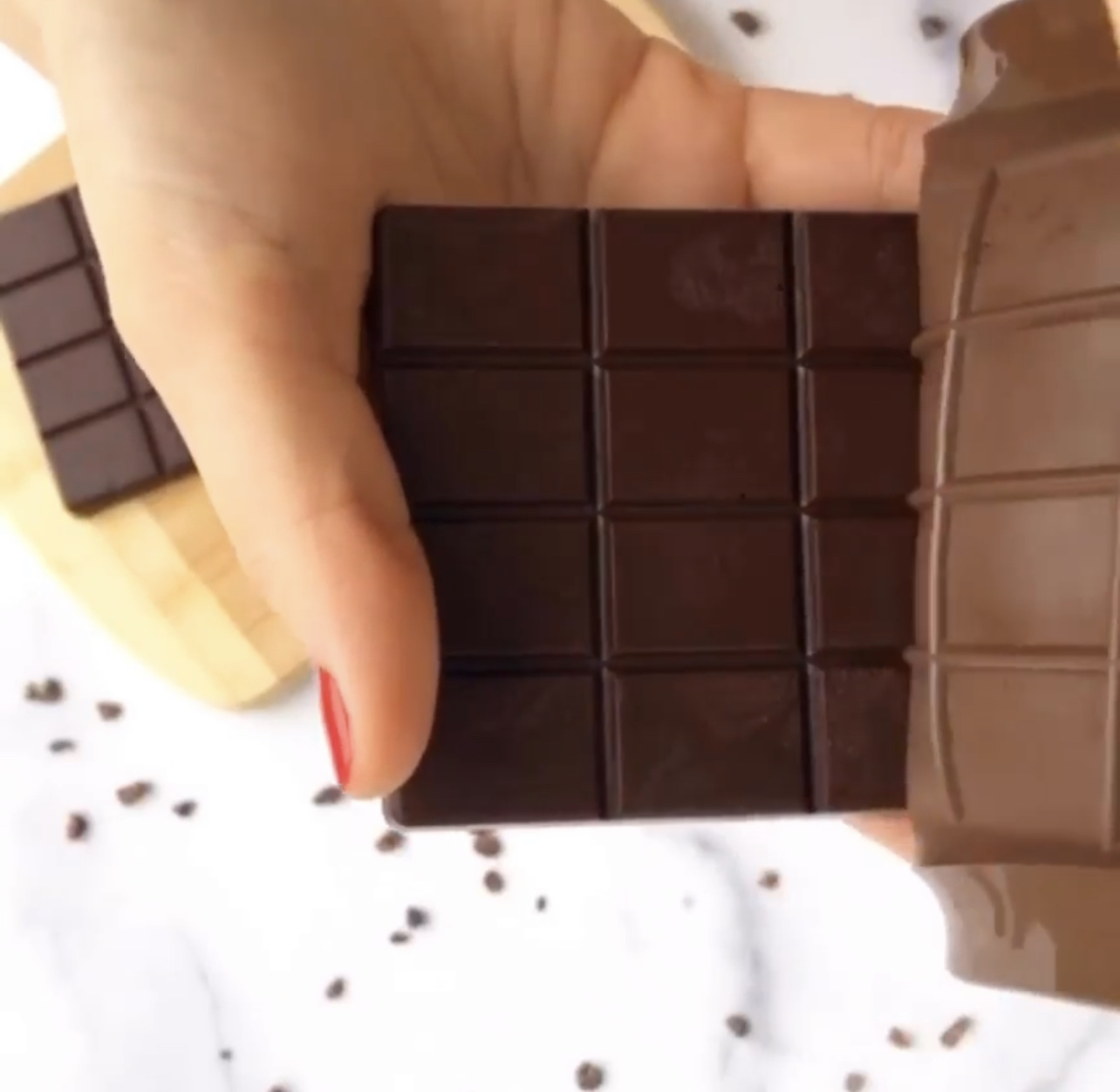 Removing a vegan chocolate bar from the chocolate mold.