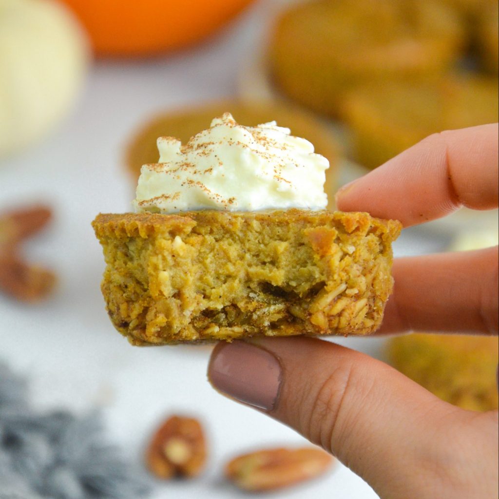 hand holding a mini pumpkin cheesecake