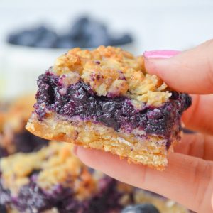 hand holding a blueberry crumble bar