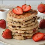 stack on pancakes with strawberries on top