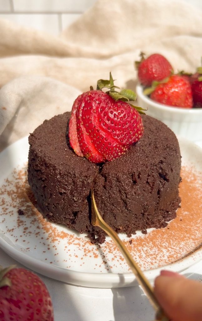 lava cake on a plate with a strawberry on top