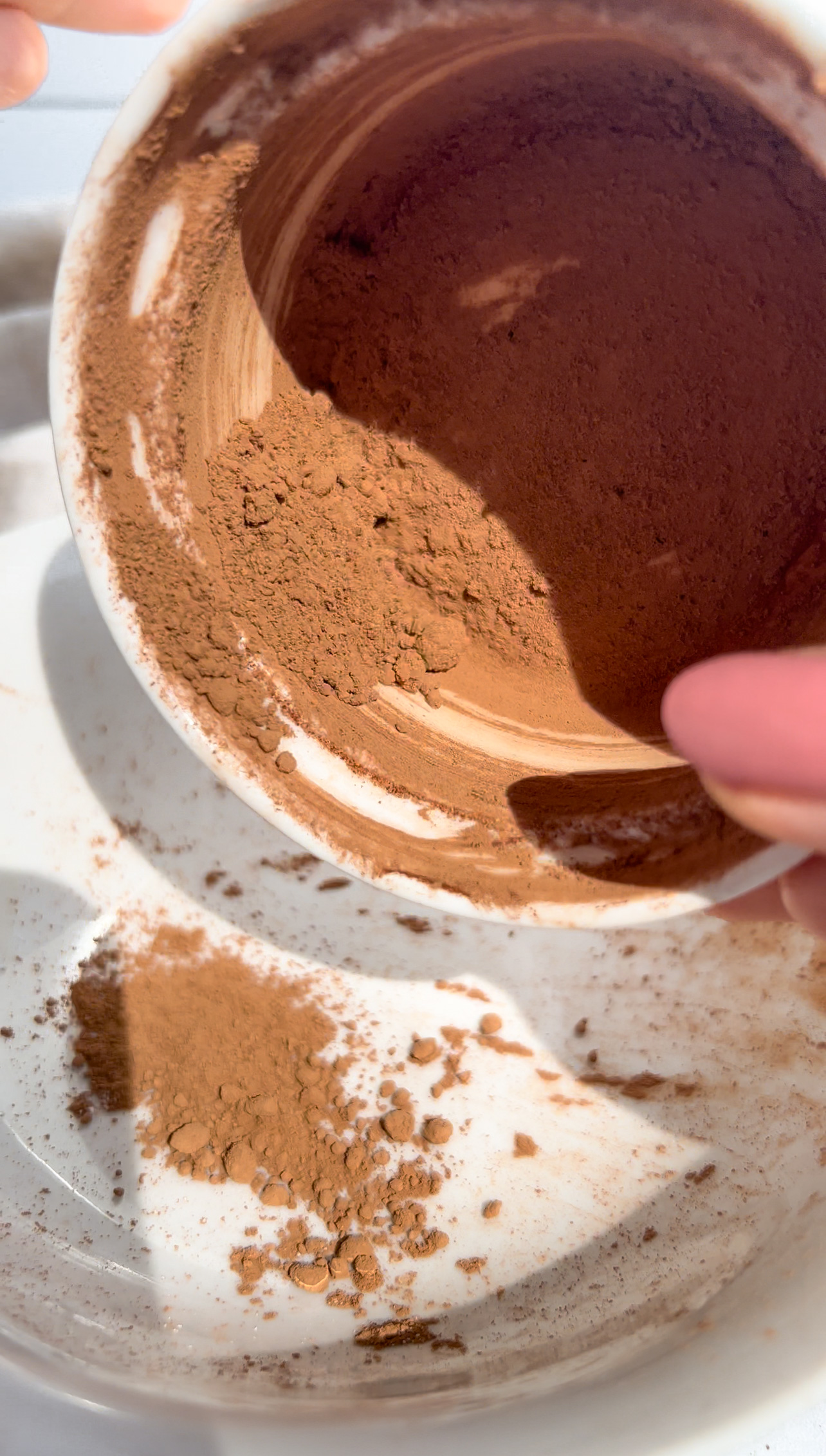 dusting cacao on a bowl