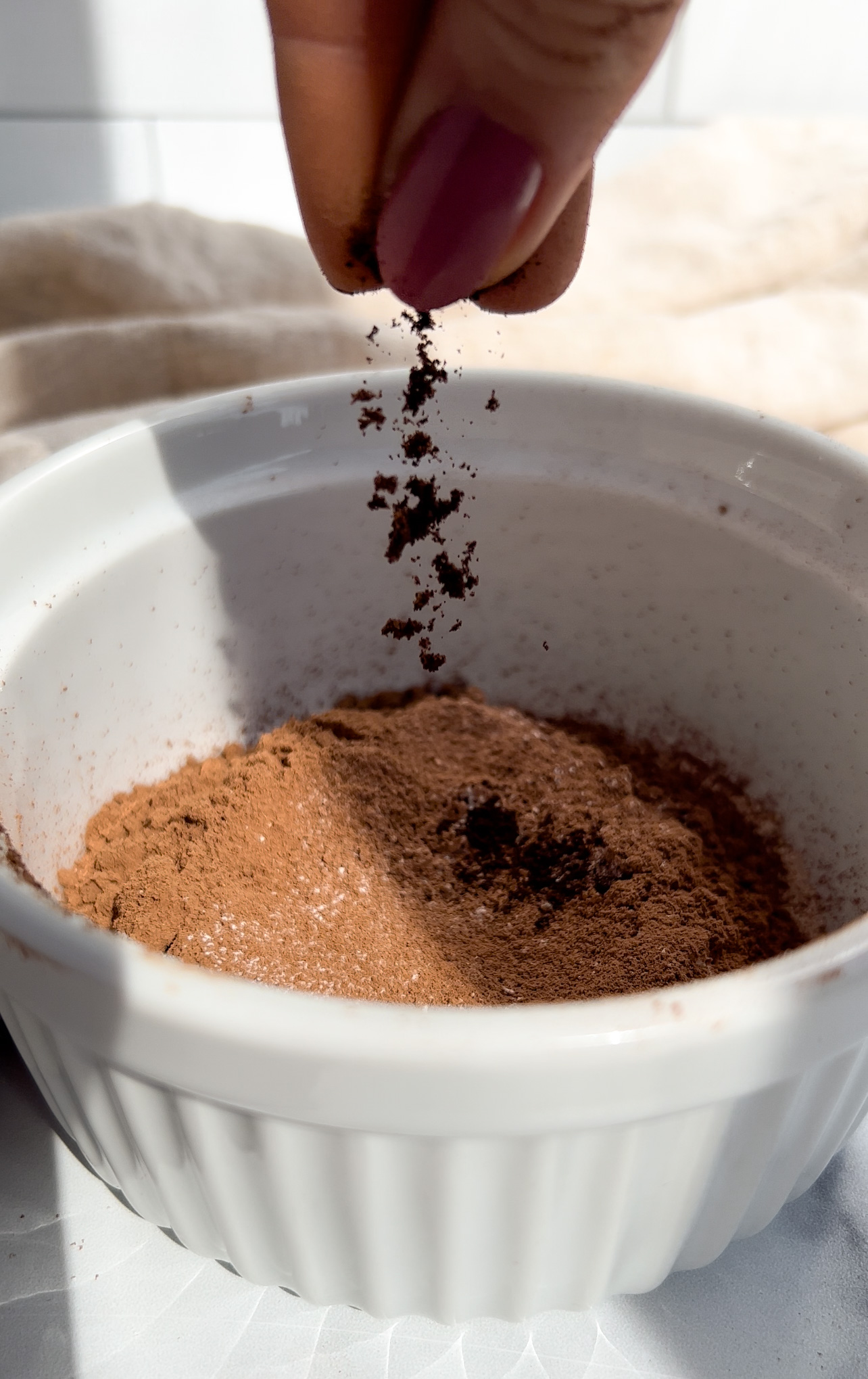 espresso powder being added to a bowl