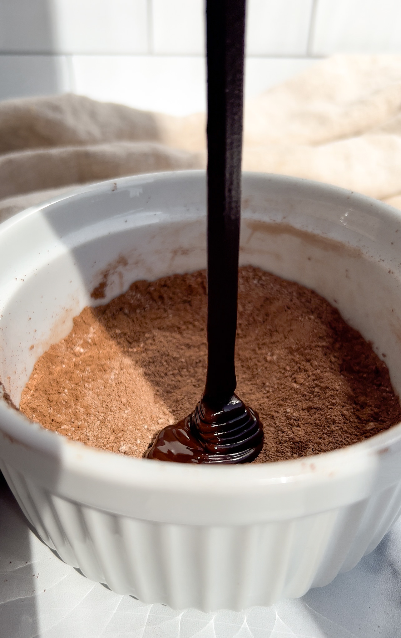 melted chocolate being added to a bowl