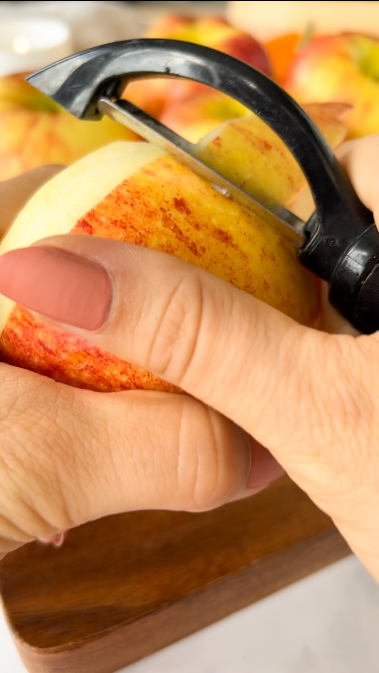 hand peeling an apple