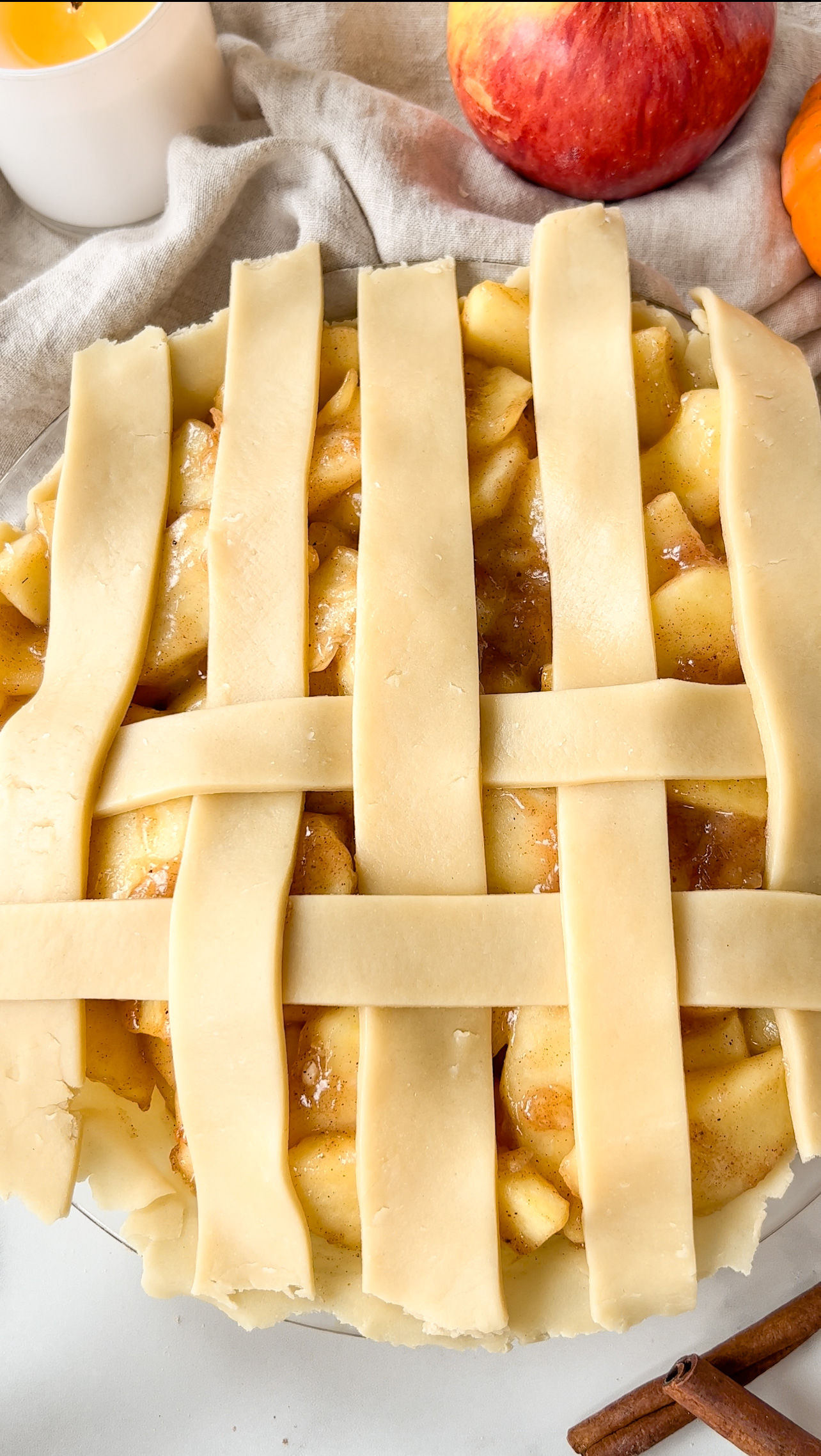 showing the process of making a pie lattice on top of apple pie