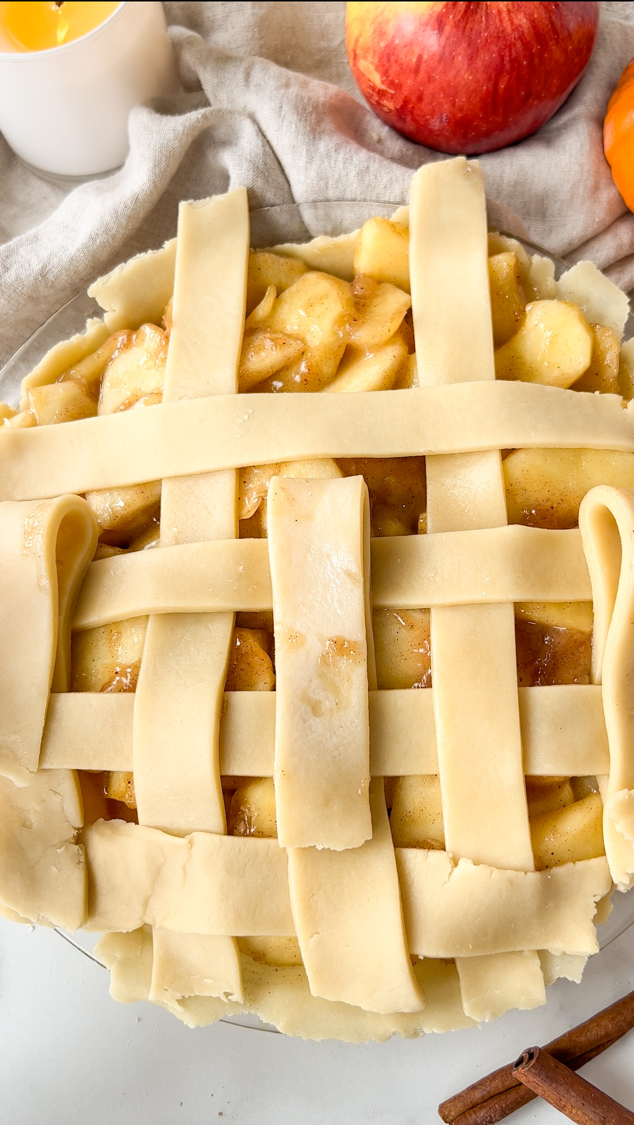 showing the process of making a pie lattice on top of apple pie