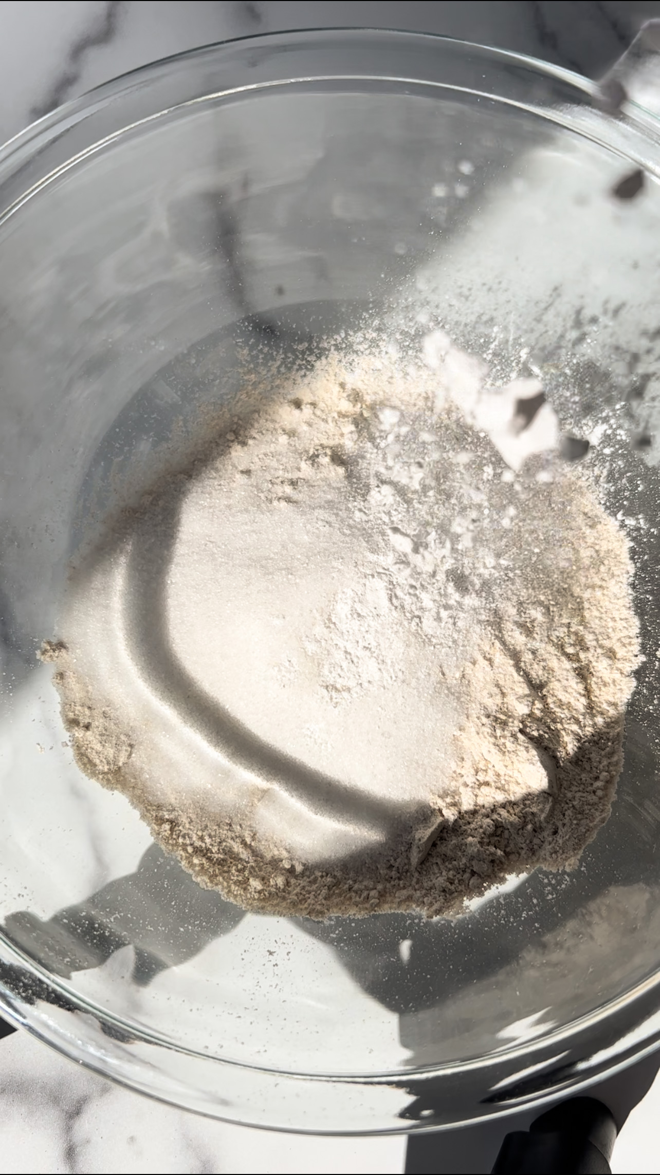 adding baking powder to a glass bowl