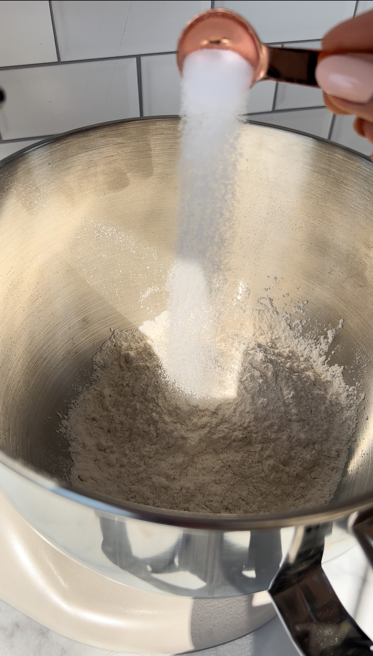 adding salt to a large bowl