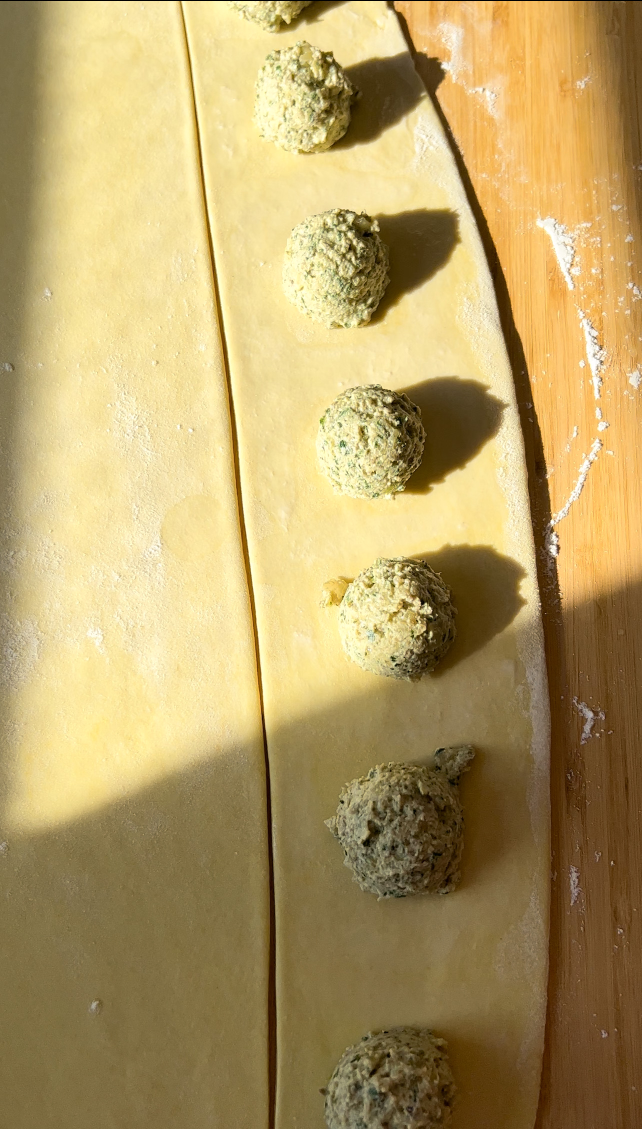 ravioli filling on a dough sheet