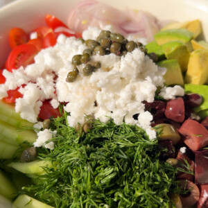 A close up of a vegan greek salad in a bowl.