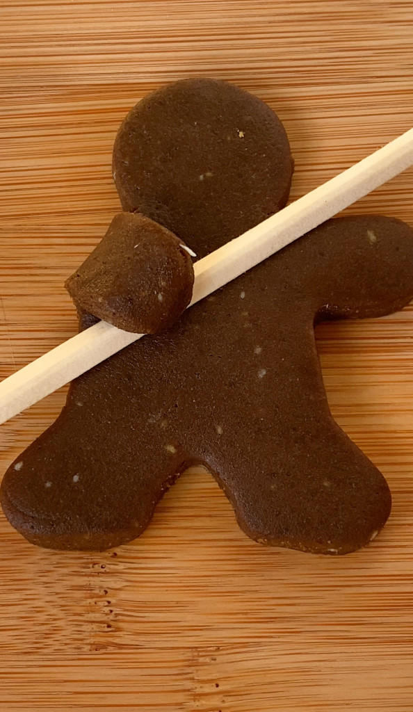 vegan gingerbread cookie holding a chop stick