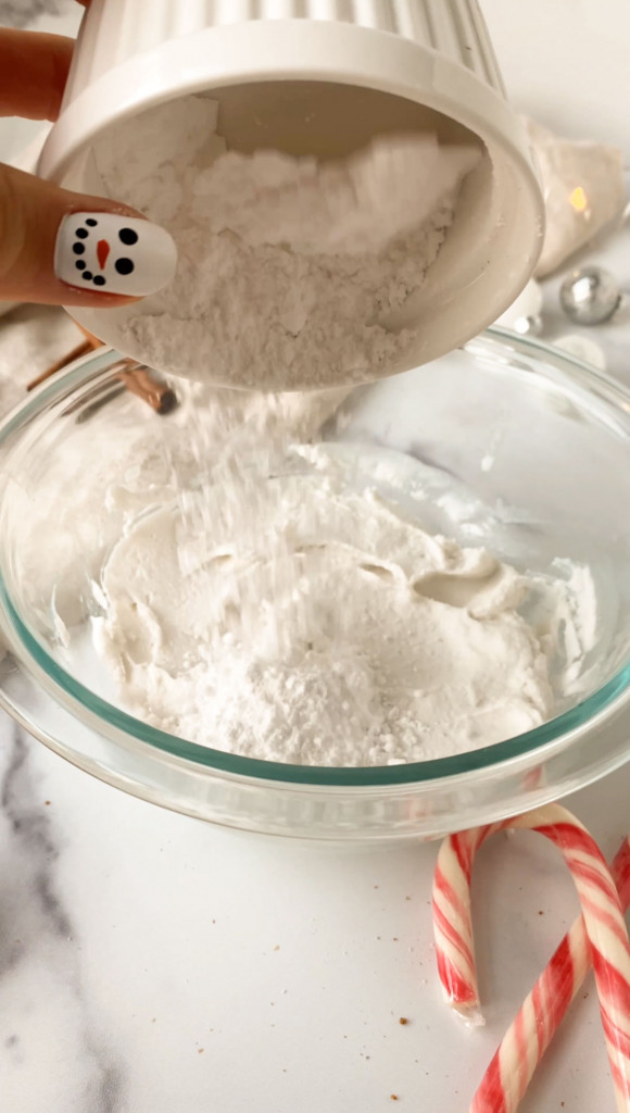 adding powdered sugar to a bowl