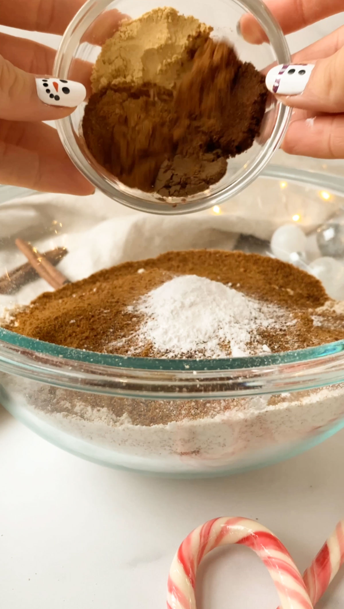 adding spices to a glass bowl of ingredients