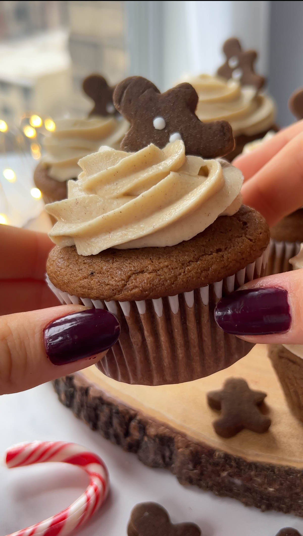 hand holding a gingerbread cupcake