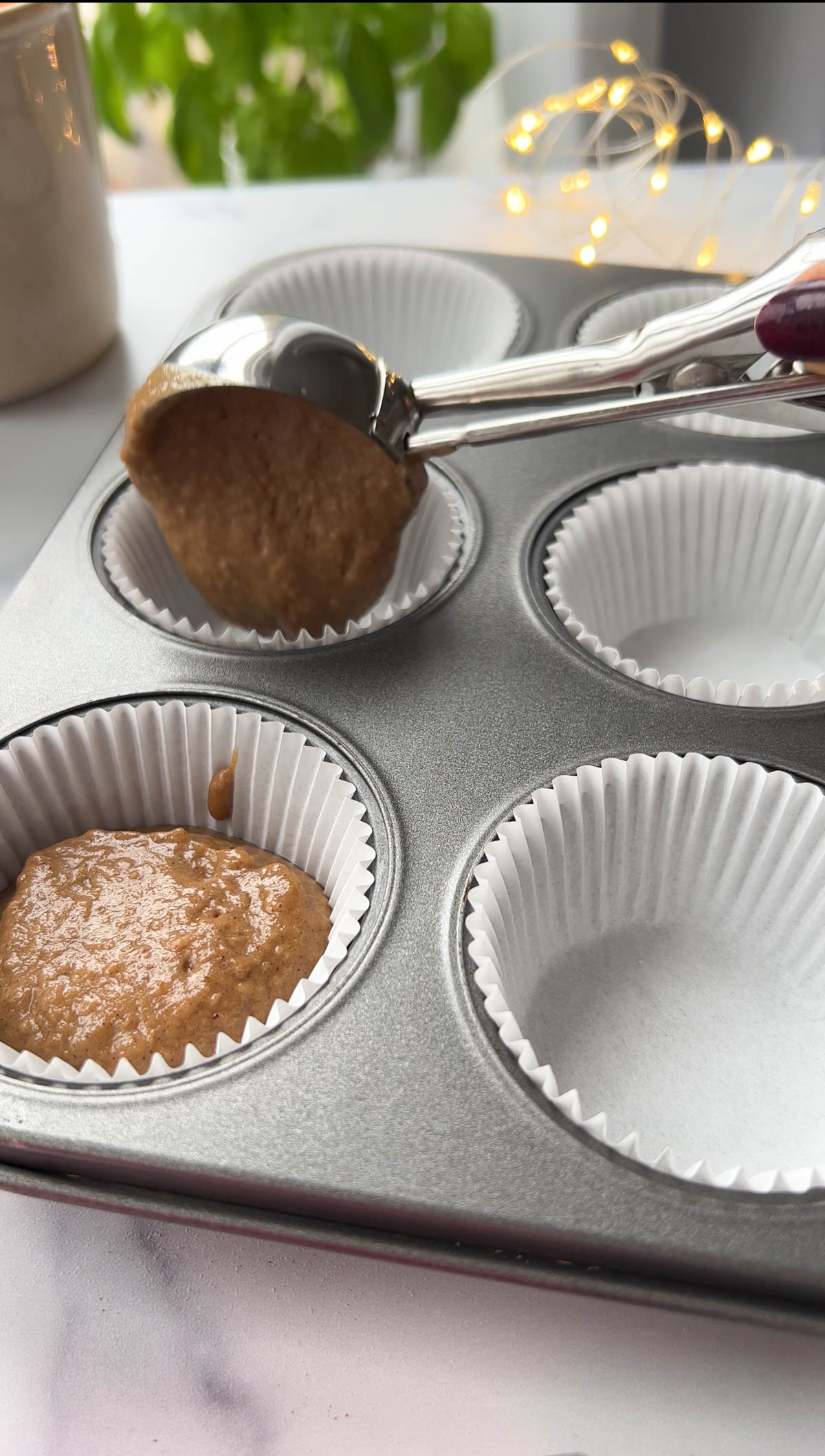 pouring gingerbread batter into cupcake molds