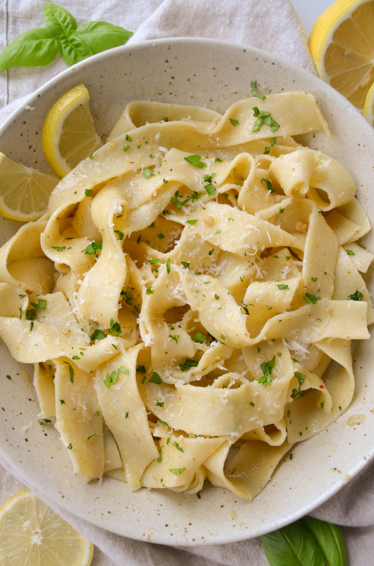 lemon garlic pasta topped with vegan parmesan and parsley