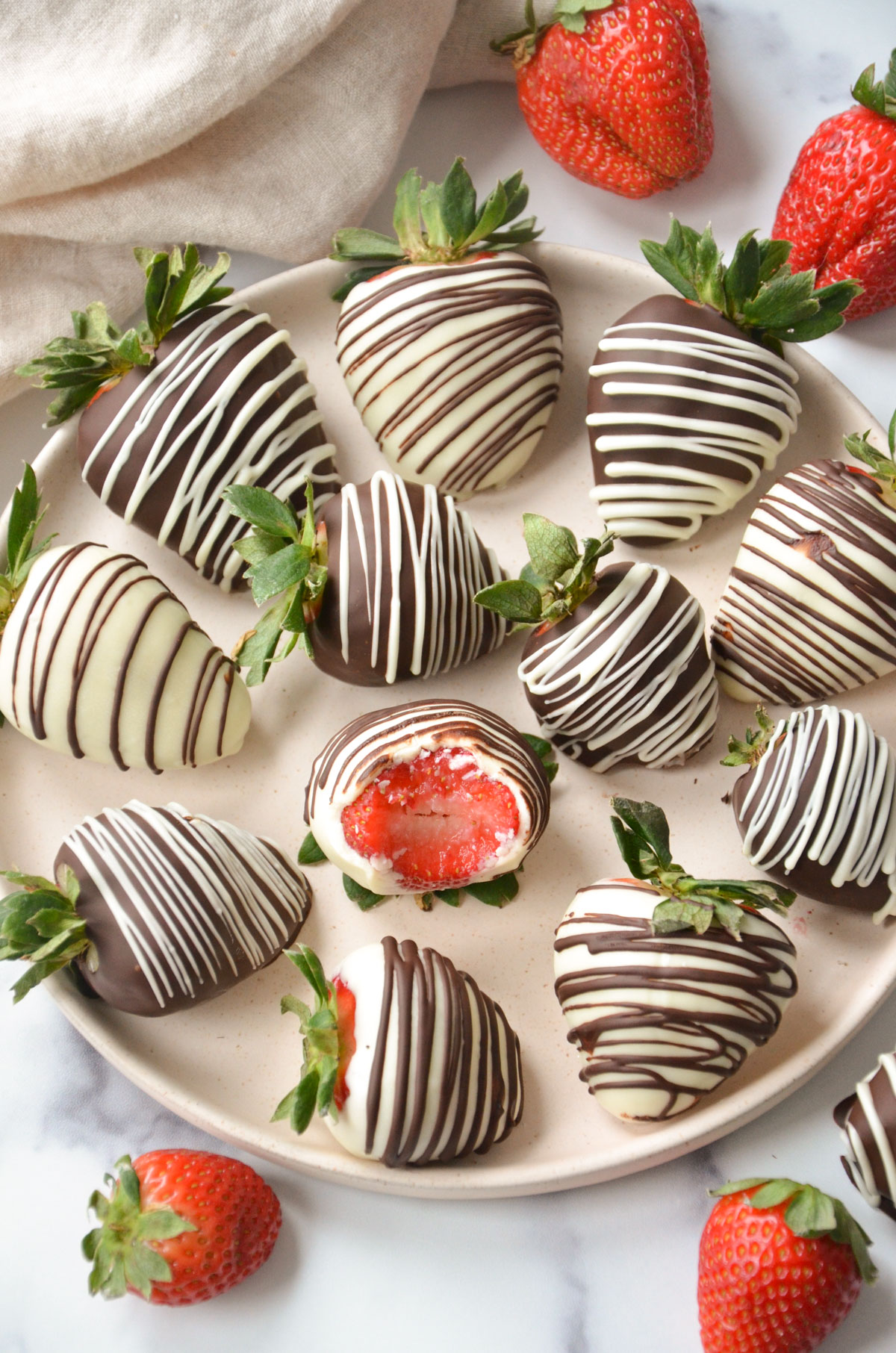 overhead shot of a plate of vegan chocolate covered strawberries