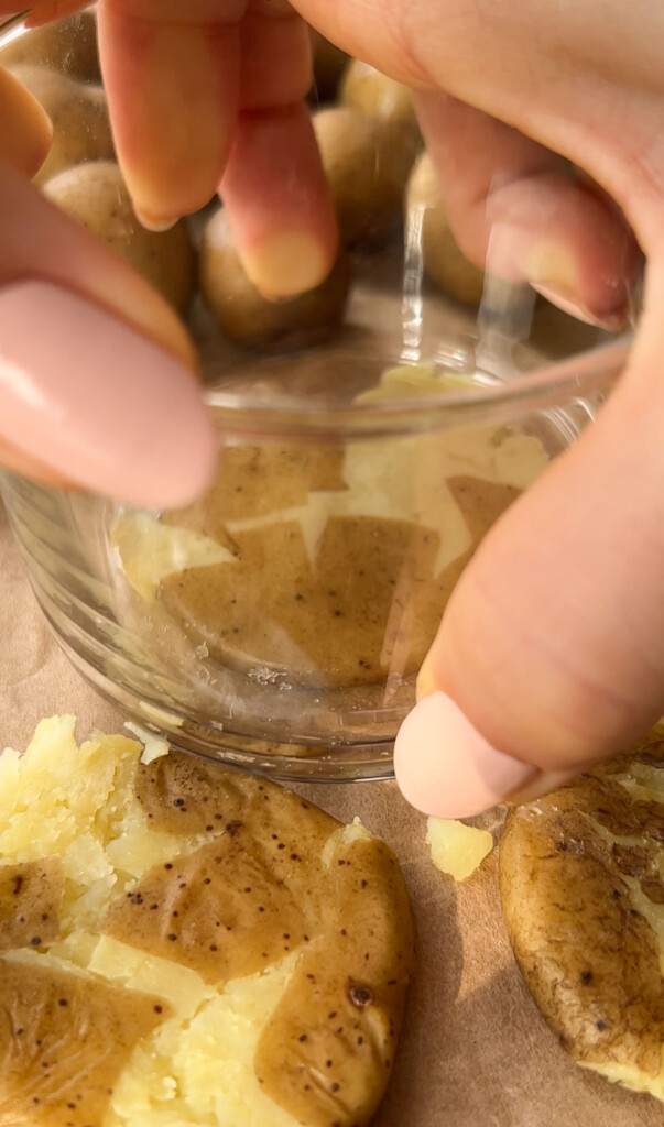 smashing a baby yukon gold potato with a glass