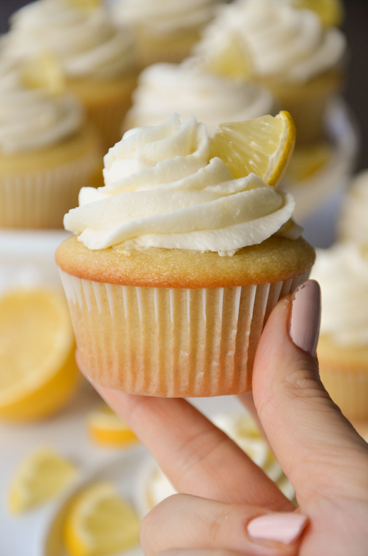 hand holding a vegan lemon cupcake