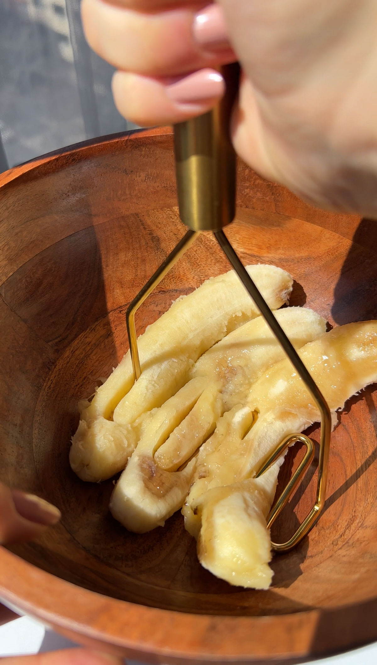 mashing ripe bananas in a bowl