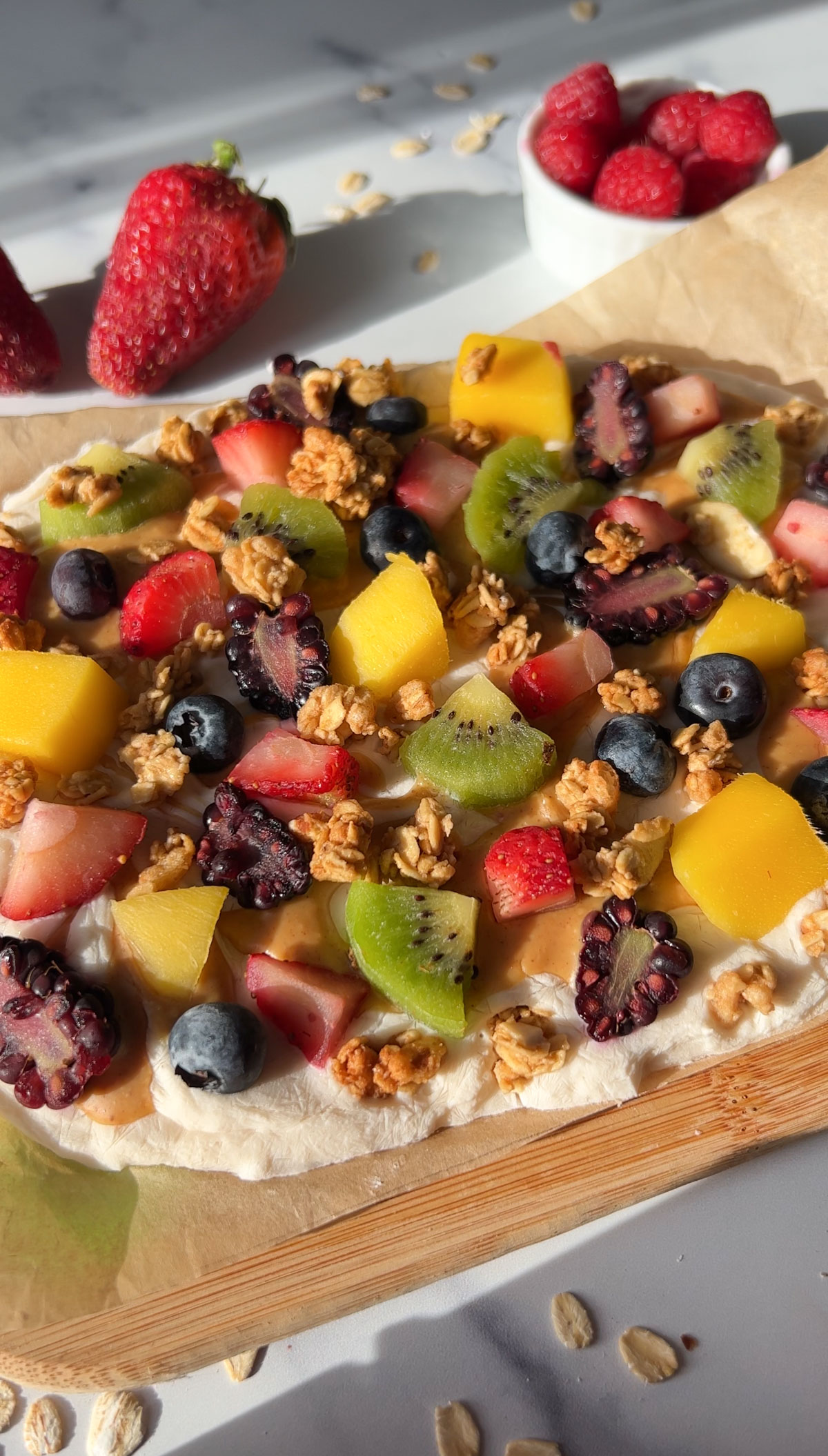 Frozen yogurt bark with berries on a baking tray.