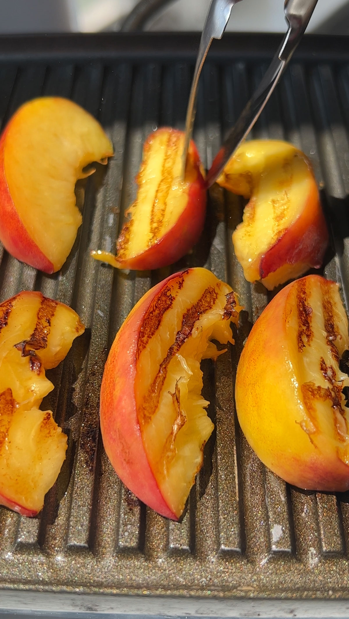 Grilling the peaches for a peach salad.
