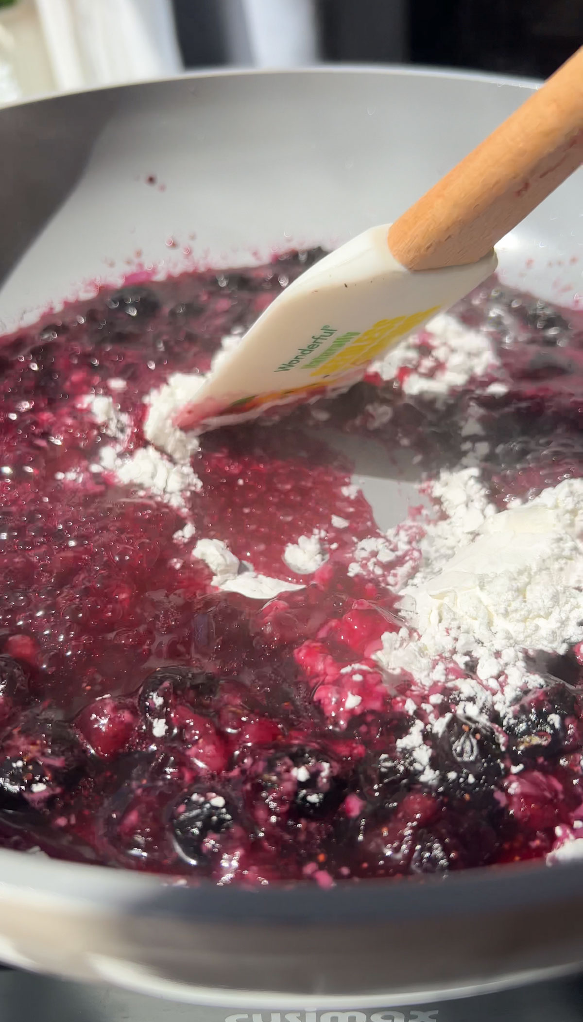 Adding the cornstarch to the blueberry mixture.