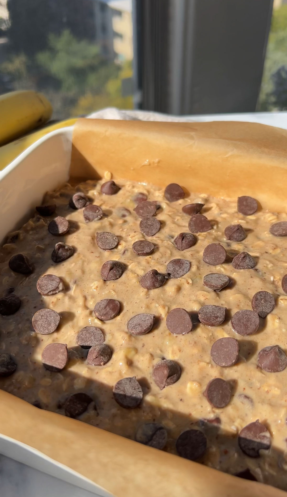 Mixture spread into a pan and topped with chocolate chips.