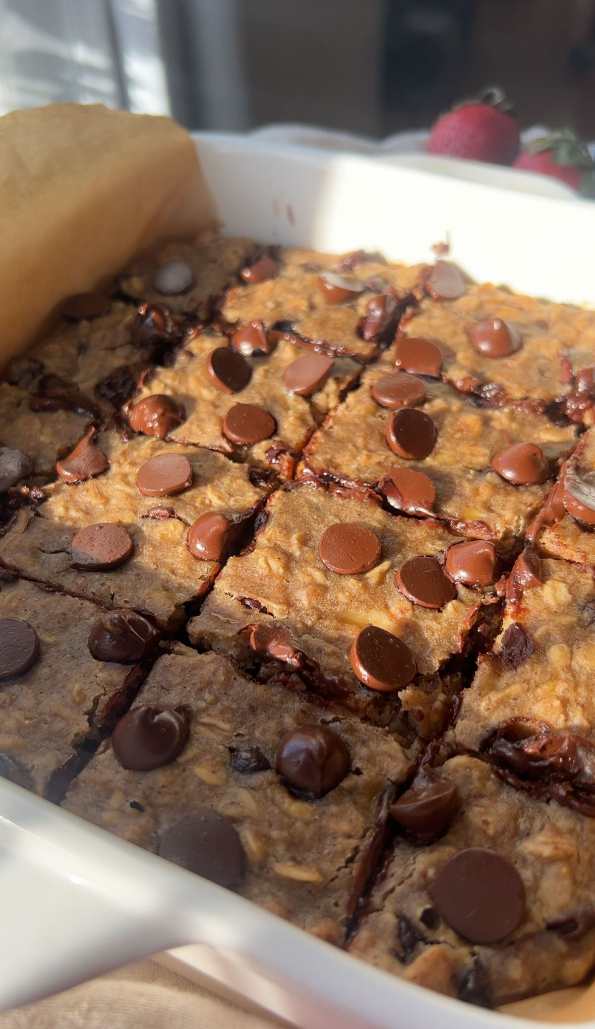 Vegan baked oat bars cut into squares in a baking dish.