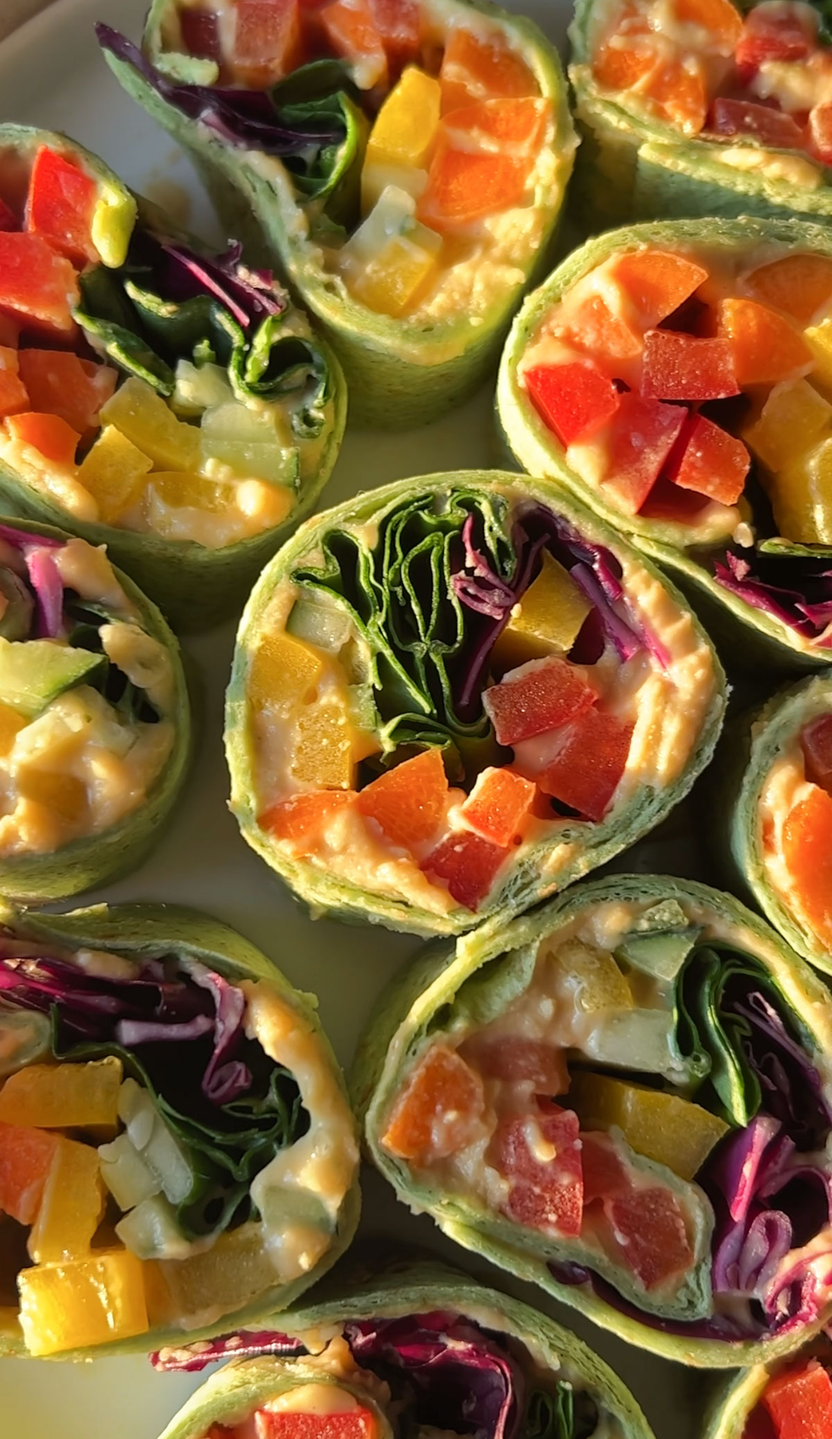 An overhead shot of vegan veggie pinwheels laid out on a plate.