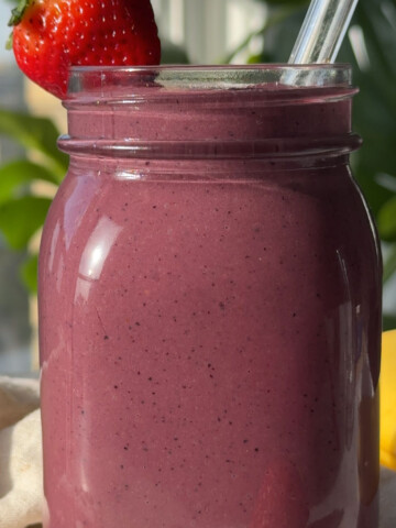 An acai smoothie in a glass.