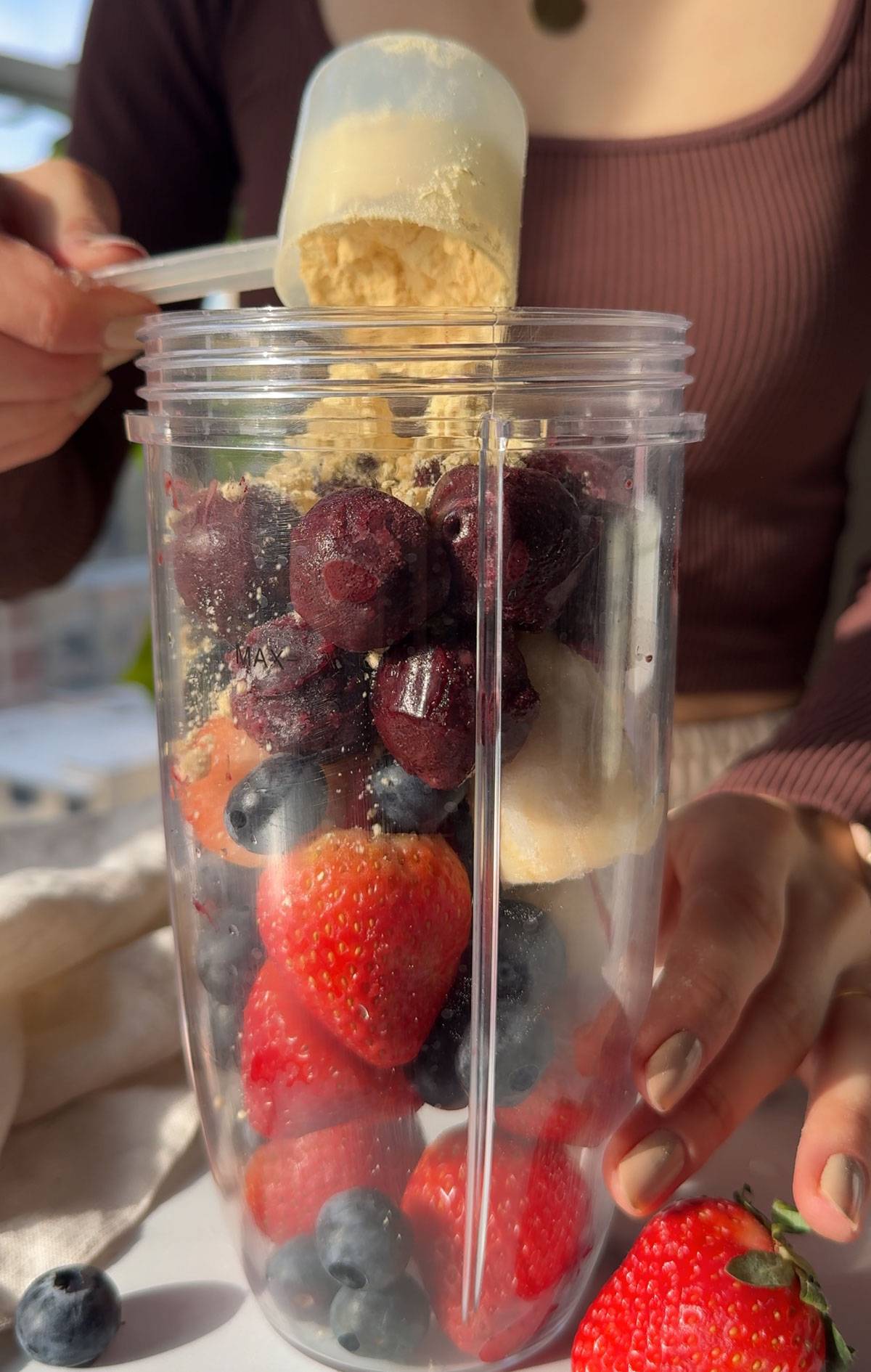 Ingredients for making an acai smoothie in a blender.
