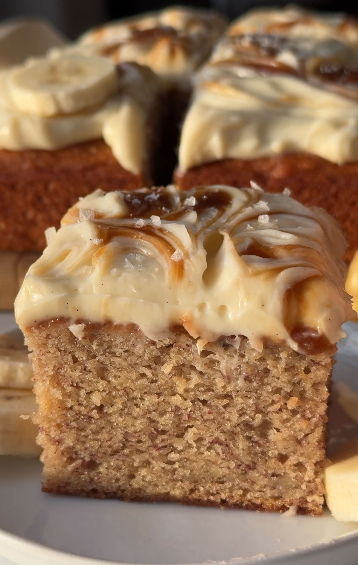 Vegan banana cake cut into squares, ready for serving.