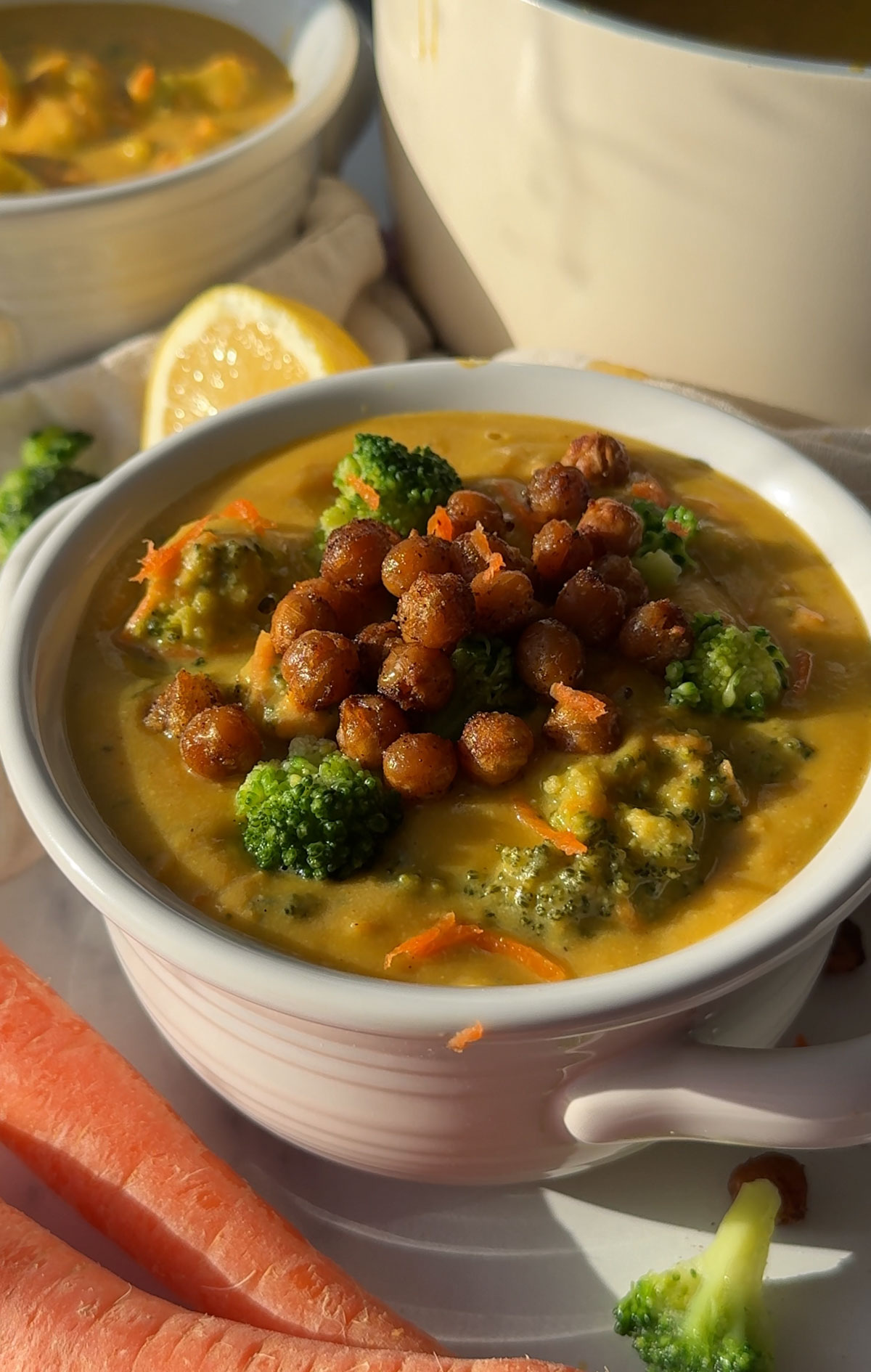 Vegan broccoli cheese soup served in a white bowl.