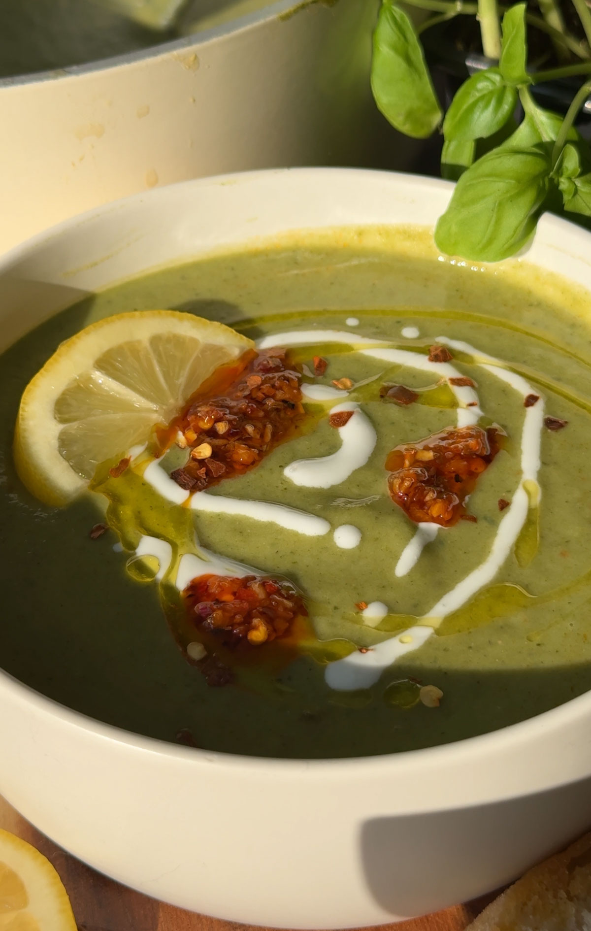Green soup in a white bowl.