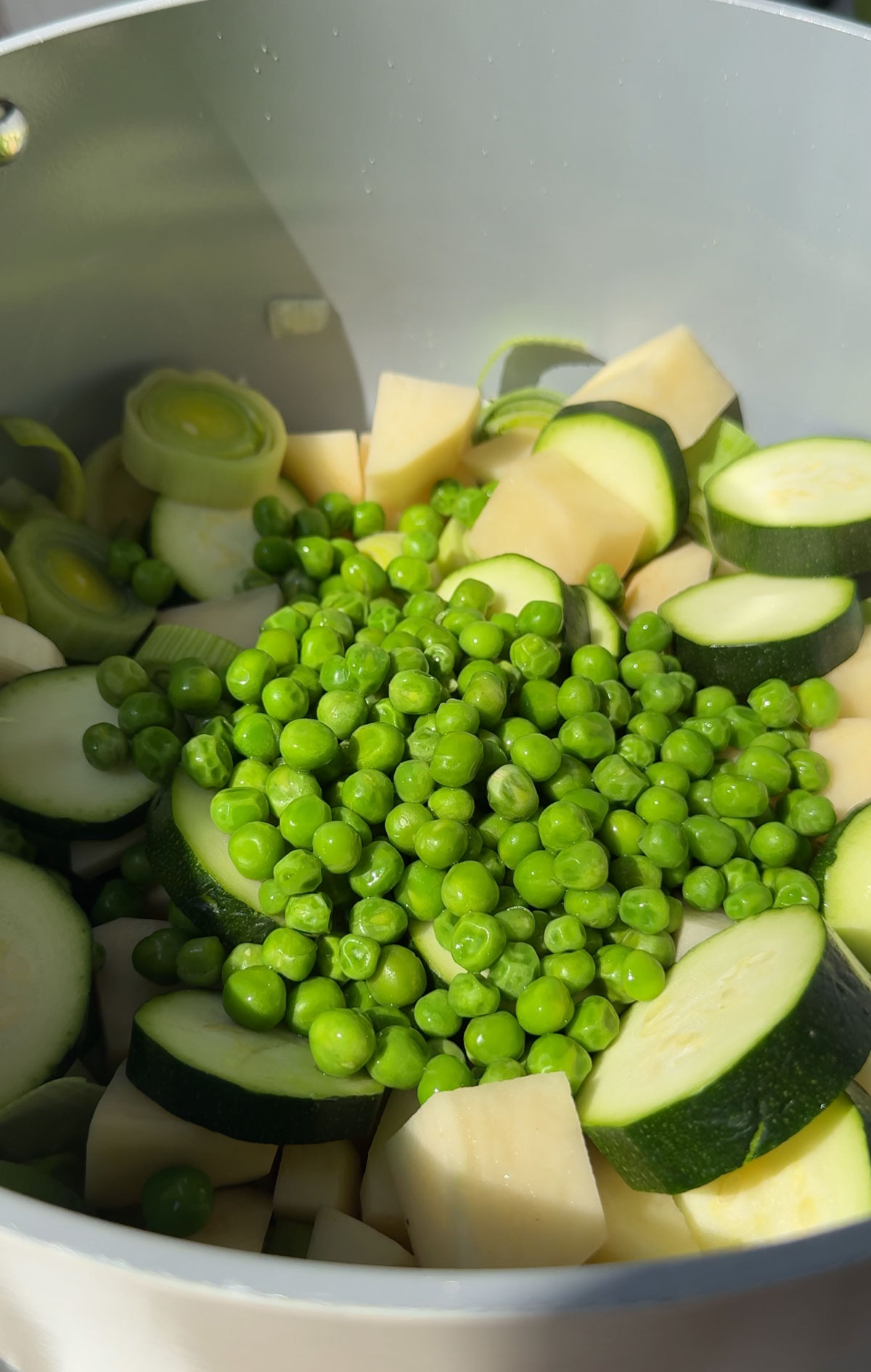 Veggies for making green soup in a pot.