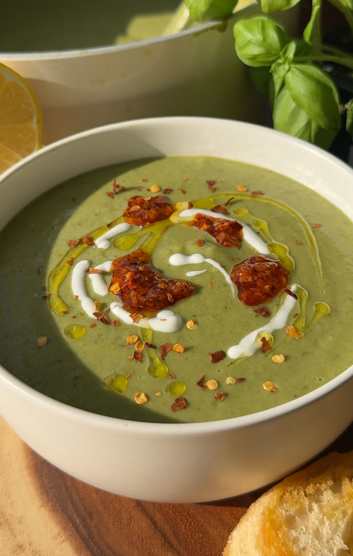 Green soup in a white bowl.