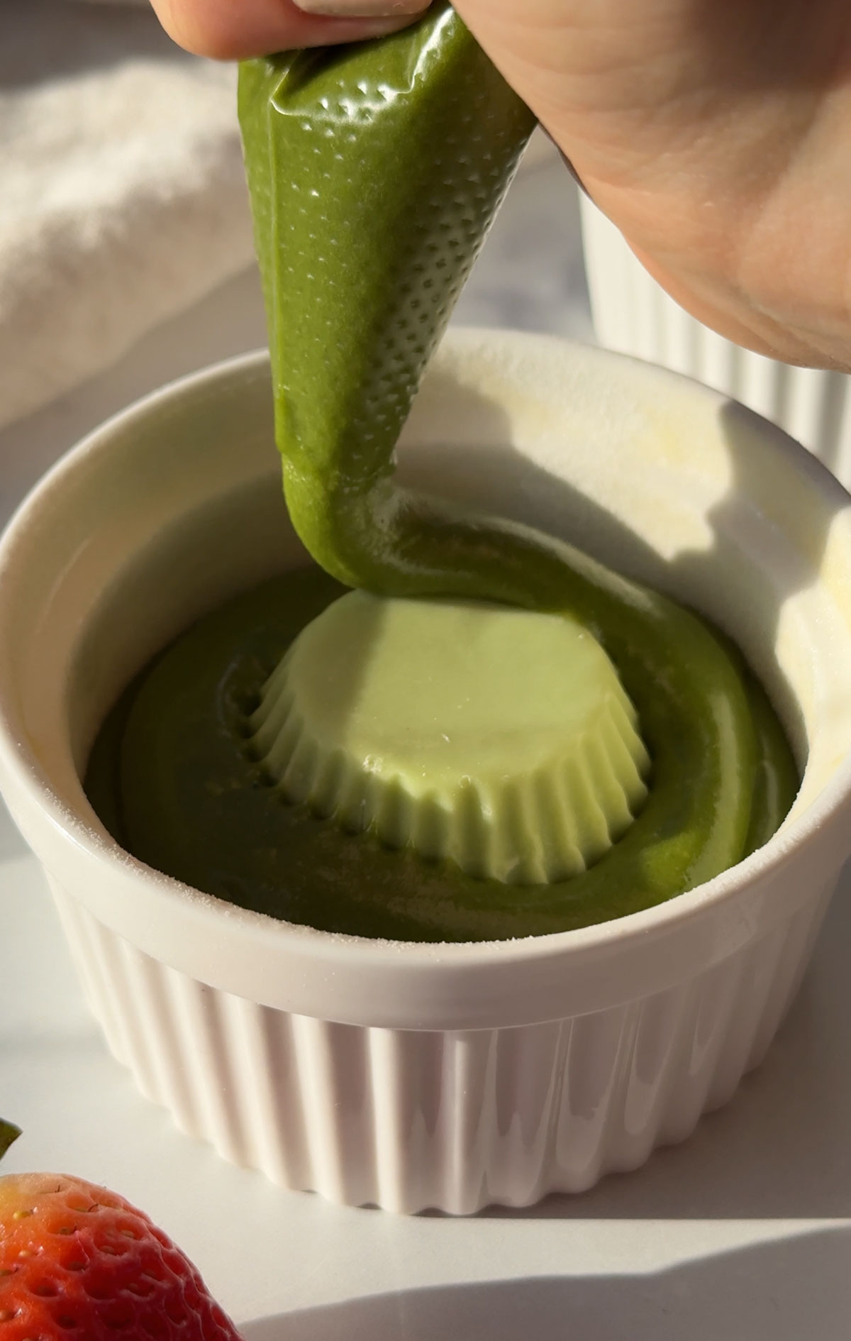 Adding cake batter around the frozen white chocolate.