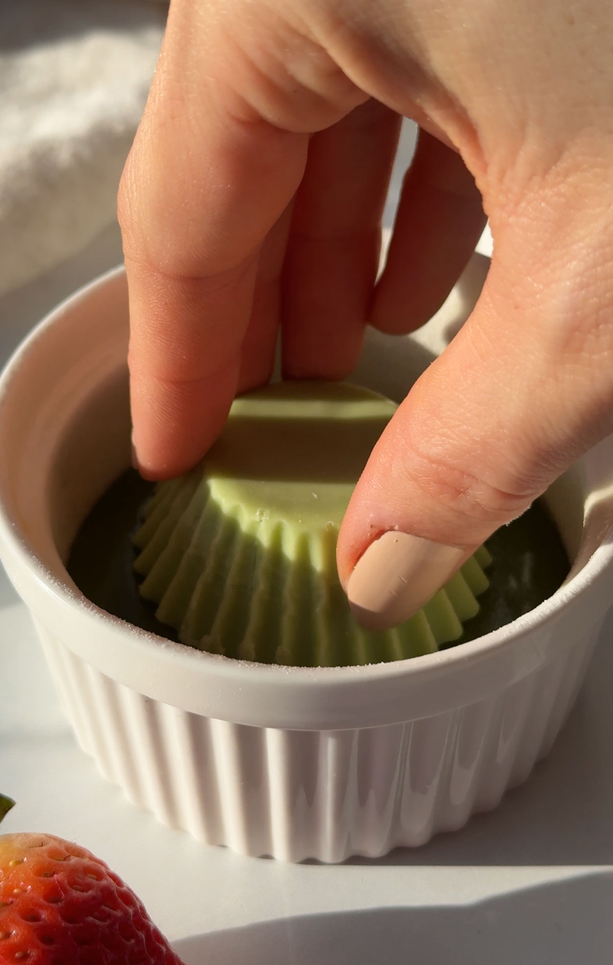 Adding the frozen white chocolate to the ramekin.