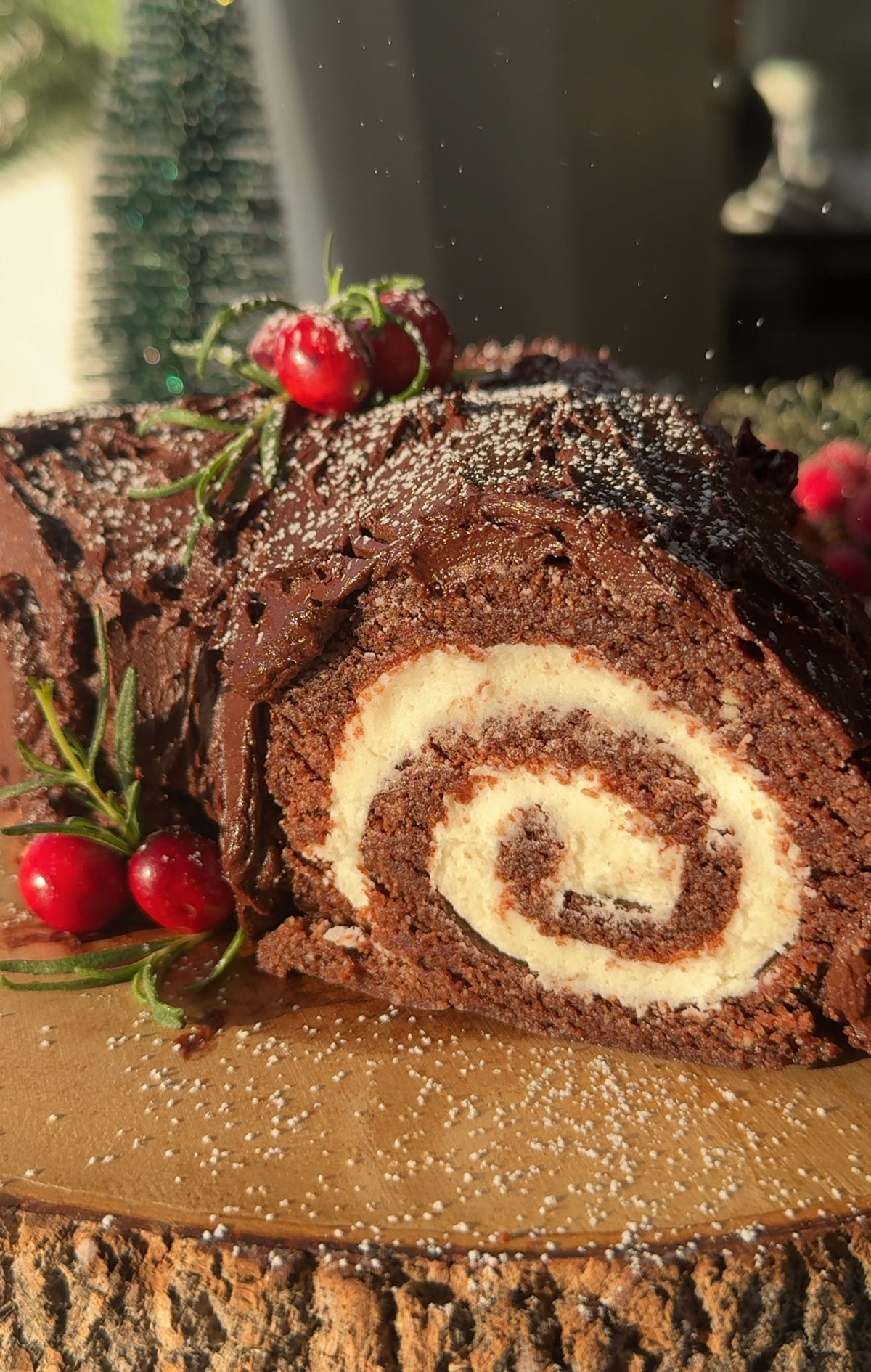 A vegan yule log recipe on a wood slice.