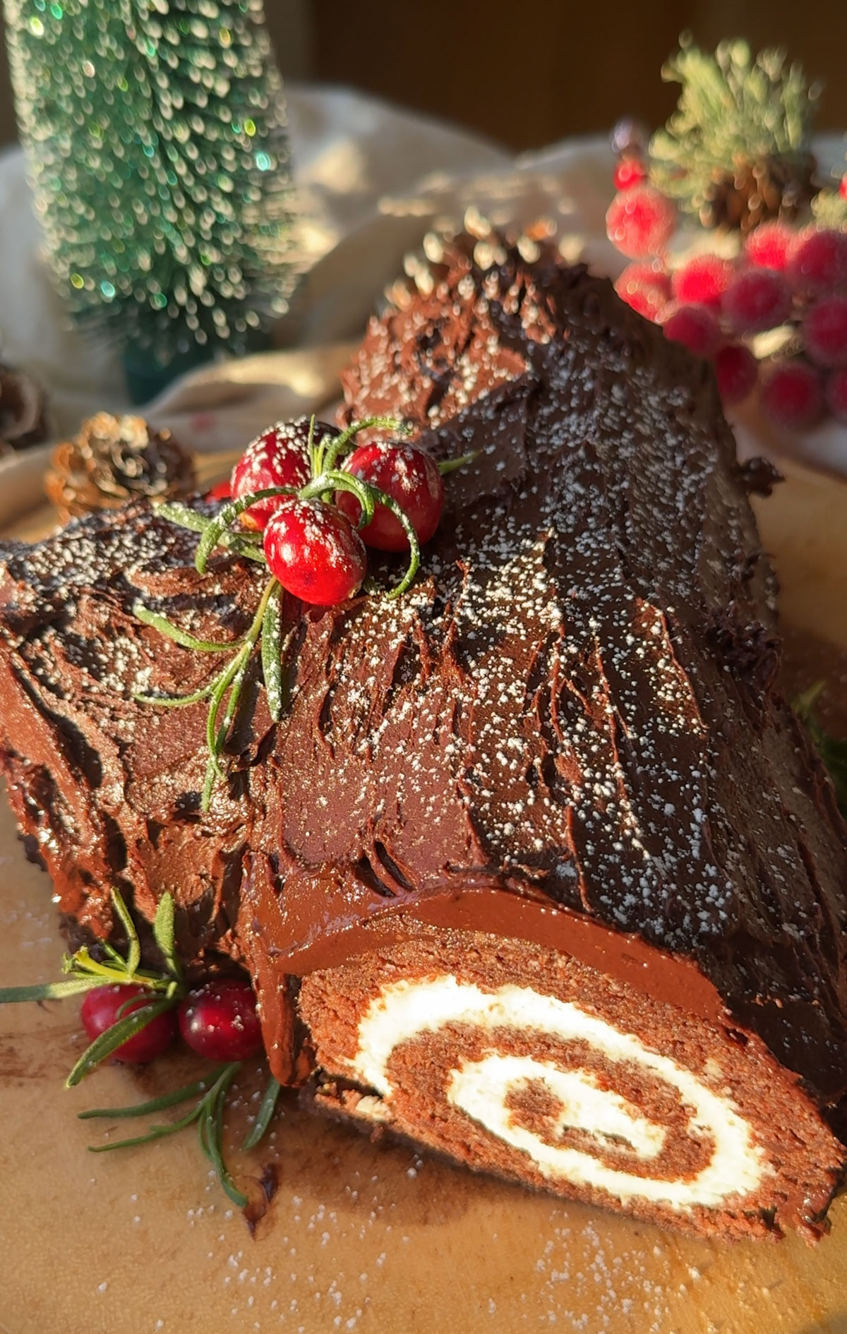 A vegan yule log recipe on a wood slice.