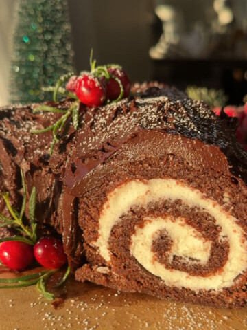 A vegan yule log recipe on a wood slice.