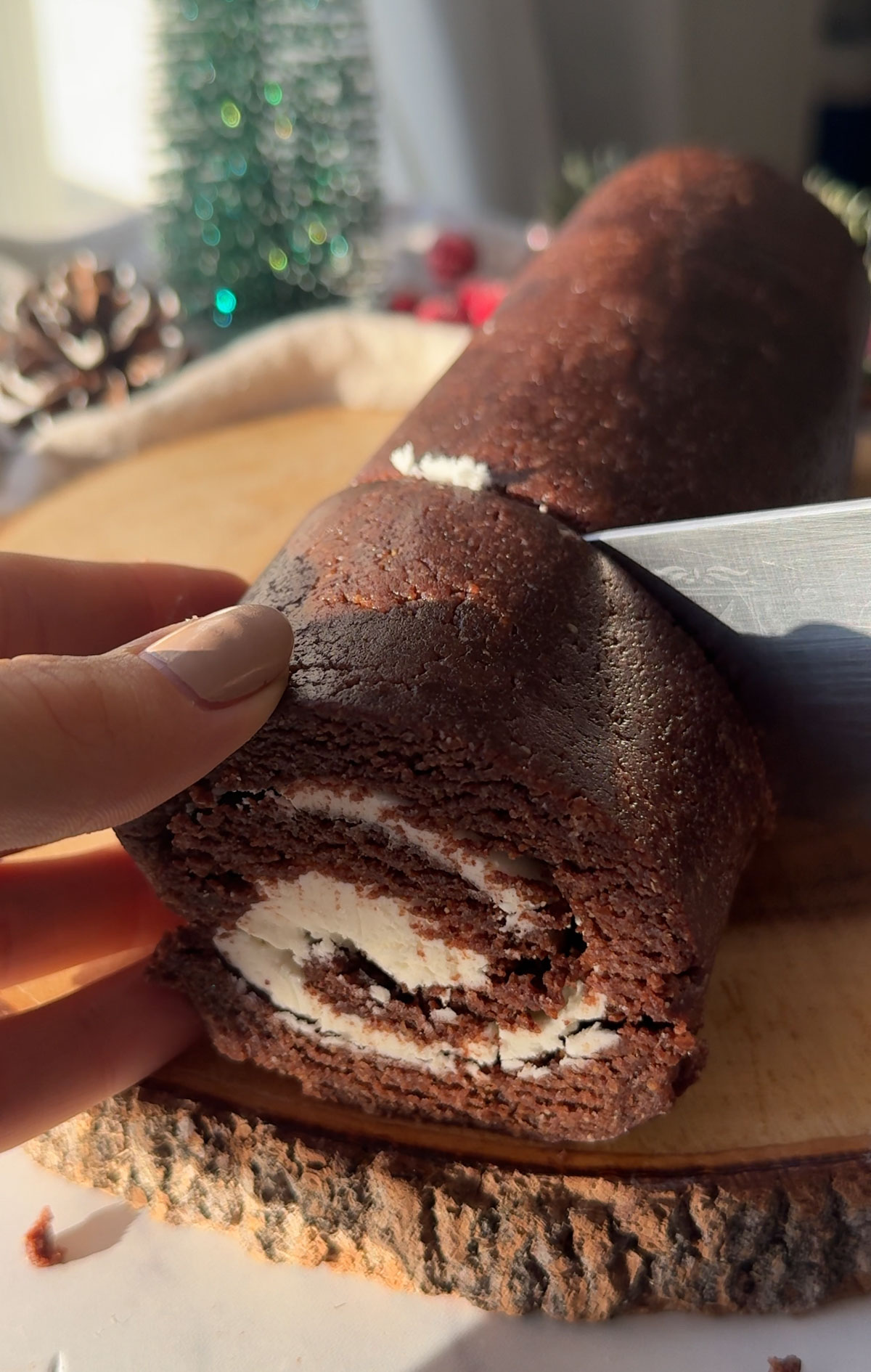 Yule log being cut with a knife.