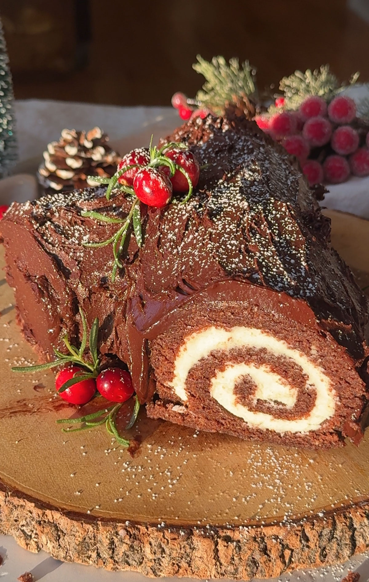 A vegan yule log recipe on a wood slice.